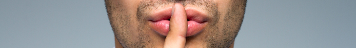 An image of a guy holding his finger over his lips